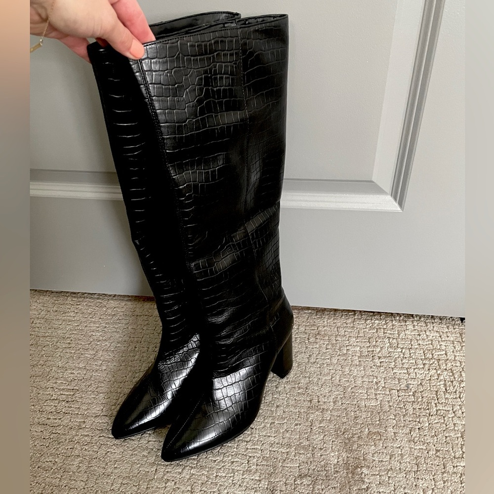 Tall leather black boots. Knee high